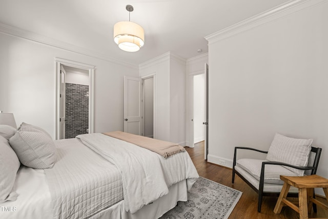 bedroom with baseboards, ornamental molding, and dark wood-style floors