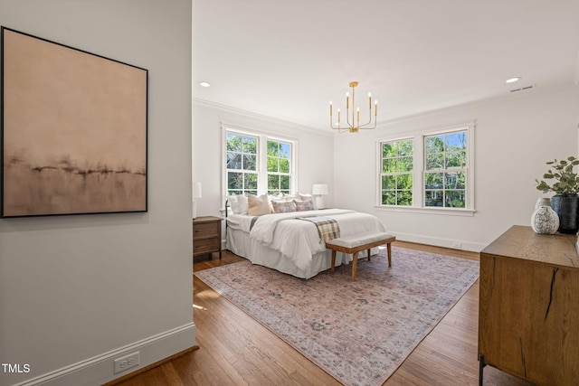 909 N Gregson St, Durham, NC 27701 - bedroom featuring baseboards, a chandelier, ornamental molding, and wood finished floors