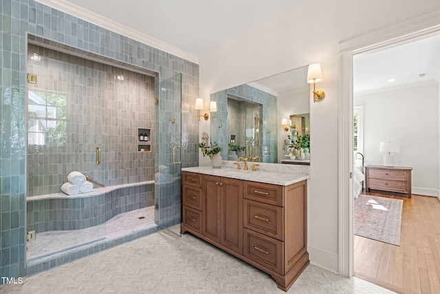 bathroom featuring crown molding, vanity, a stall shower, and wood finished floors