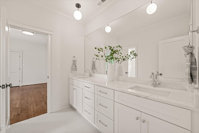 909 N Gregson St, Durham, NC 27701 - bathroom featuring crown molding, double vanity, visible vents, and a sink