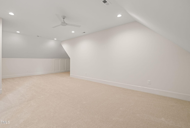 additional living space featuring ceiling fan, light colored carpet, visible vents, vaulted ceiling, and recessed lighting