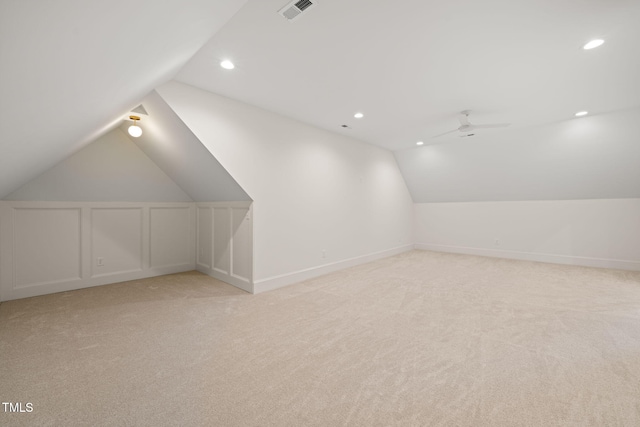 additional living space with visible vents, lofted ceiling, recessed lighting, light colored carpet, and a ceiling fan