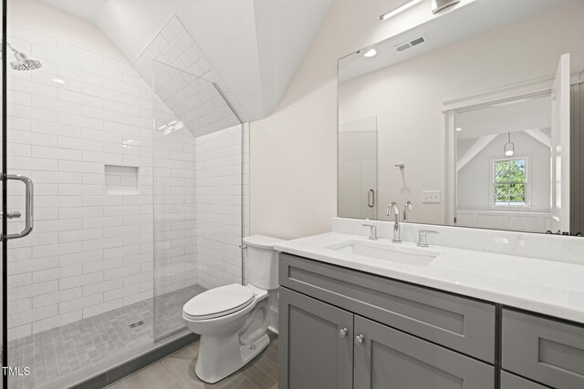 909 N Gregson St, Durham, NC 27701 - full bathroom featuring toilet, vaulted ceiling, visible vents, and a stall shower