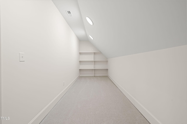 interior space featuring visible vents, lofted ceiling, baseboards, recessed lighting, and carpet flooring