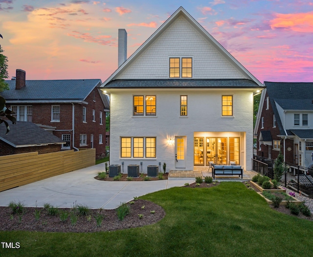back of property featuring an outdoor hangout area, a yard, a chimney, and cooling unit