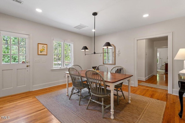 dining space featuring visible vents, baseboards, light wood finished floors, and recessed lighting
