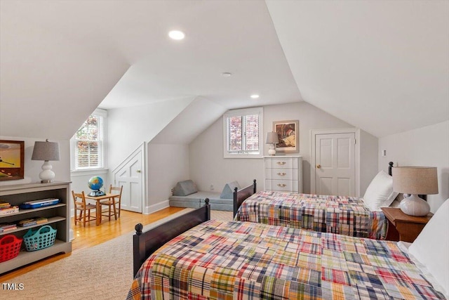 bedroom featuring wood finished floors, multiple windows, lofted ceiling, and recessed lighting