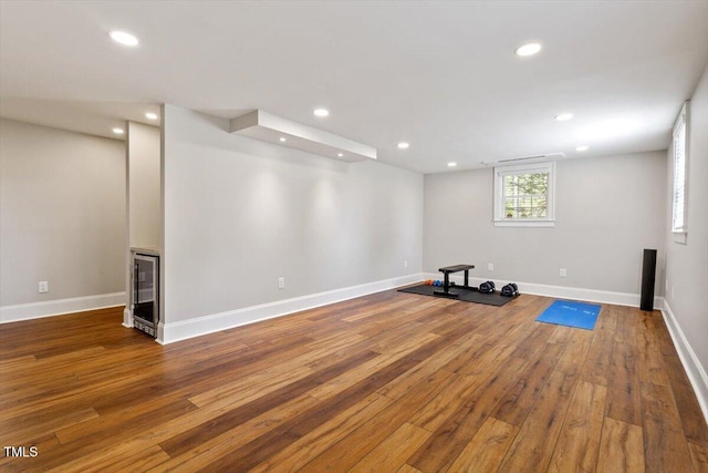 workout room featuring recessed lighting and hardwood / wood-style floors