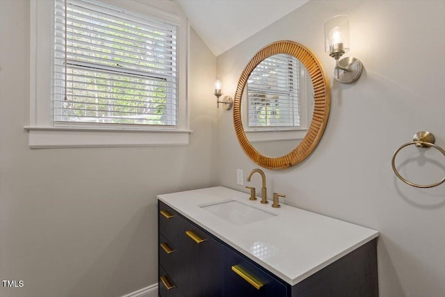 bathroom with vanity and vaulted ceiling