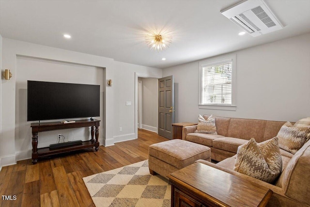 living room with visible vents, baseboards, recessed lighting, and wood finished floors