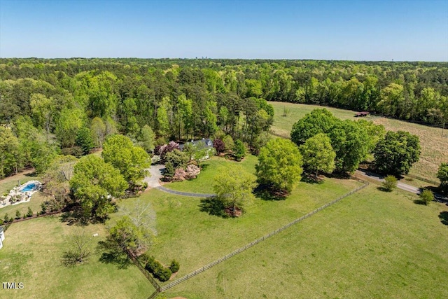 birds eye view of property featuring a view of trees and a rural view