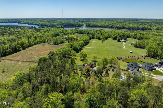 drone / aerial view with a water view and a forest view