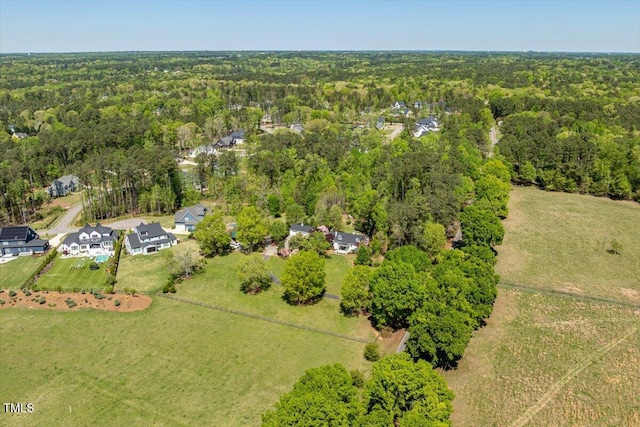 birds eye view of property with a wooded view