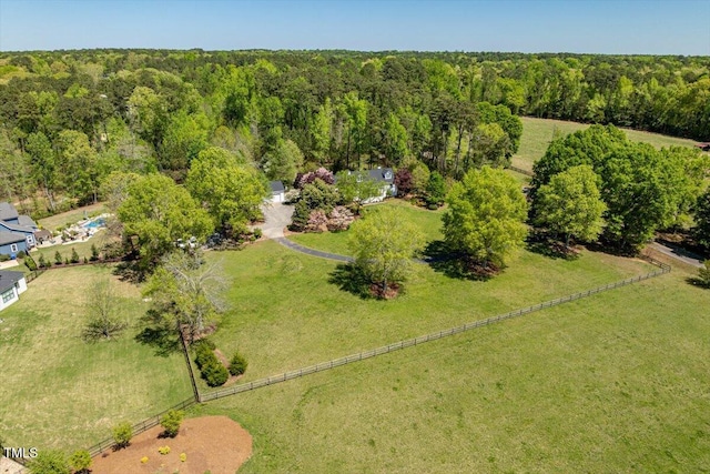 birds eye view of property with a view of trees