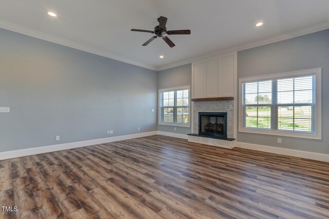 unfurnished living room featuring crown molding, baseboards, ceiling fan, recessed lighting, and dark wood finished floors