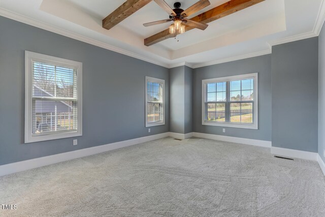 carpeted spare room featuring baseboards, visible vents, and a raised ceiling