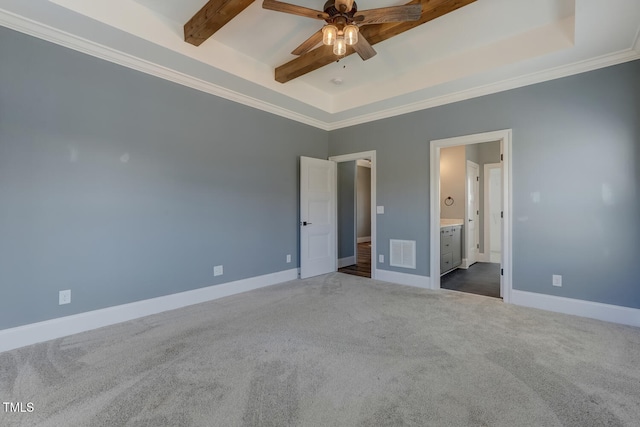 unfurnished bedroom with baseboards, carpet floors, ensuite bath, beamed ceiling, and visible vents