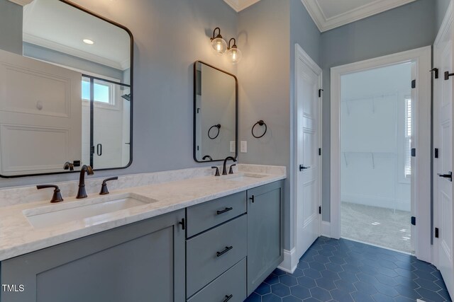 full bath featuring a shower stall, double vanity, ornamental molding, and a sink