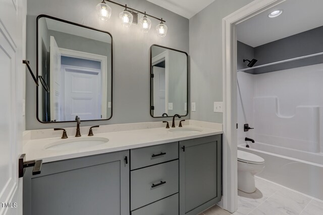 full bathroom with double vanity,  shower combination, toilet, and a sink