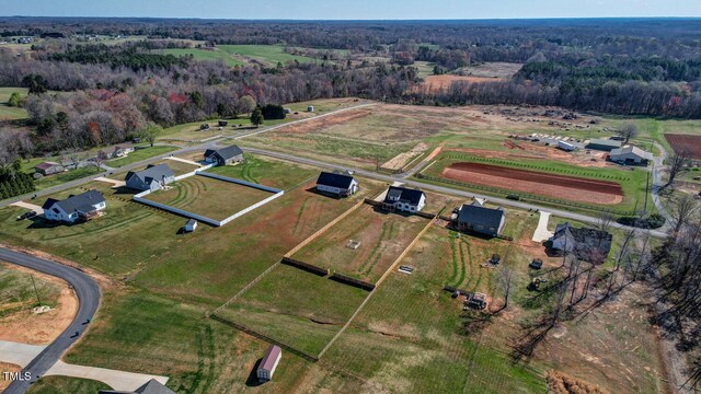 birds eye view of property with a rural view