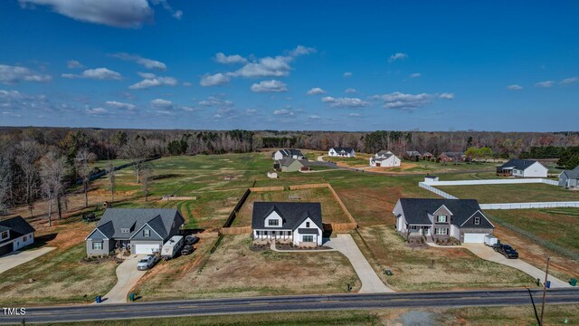 birds eye view of property with a wooded view