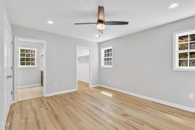 852 Fred Wilder Rd, Franklinton, NC 27525 - unfurnished bedroom with baseboards, recessed lighting, light wood-style flooring, a closet, and a walk in closet