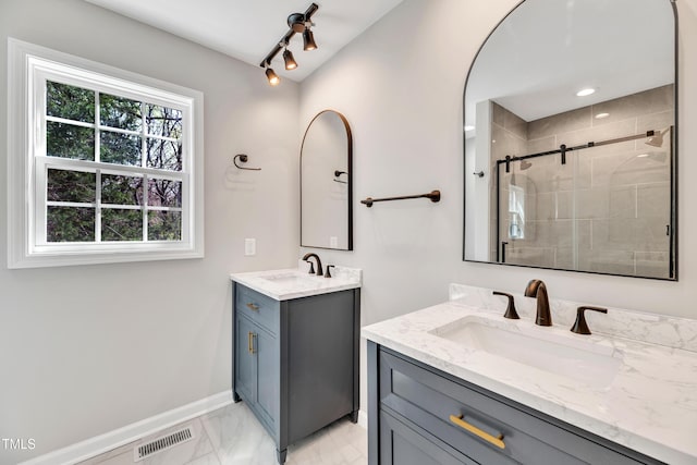 852 Fred Wilder Rd, Franklinton, NC 27525 - bathroom featuring marble finish flooring, two vanities, a stall shower, and baseboards