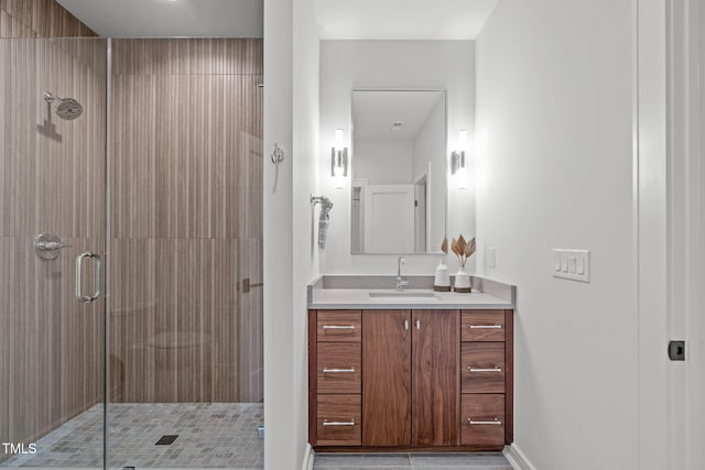 full bathroom with vanity, tile patterned flooring, baseboards, and a stall shower