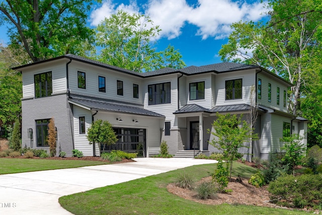 view of front of home featuring concrete driveway, a standing seam roof, metal roof, and a garage