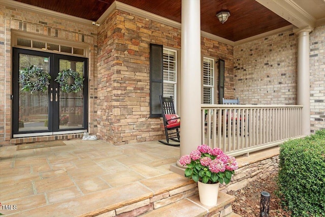 1525 Marshall Farm St, Wake Forest, NC 27587 - doorway to property featuring covered porch, stone siding, brick siding, and french doors
