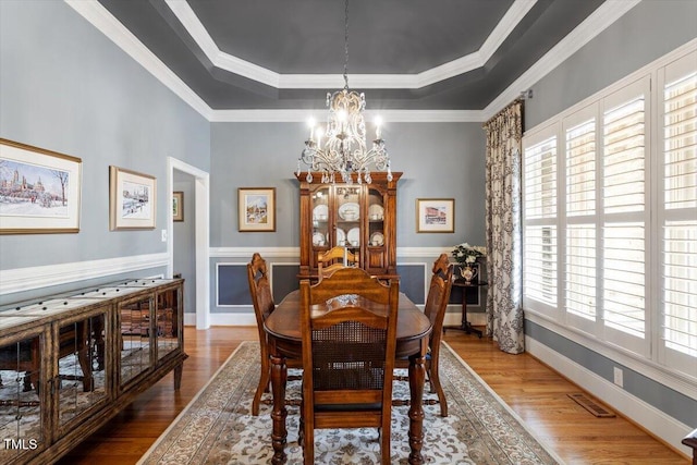 1525 Marshall Farm St, Wake Forest, NC 27587 - dining room featuring a tray ceiling, wood finished floors, a chandelier, and ornamental molding