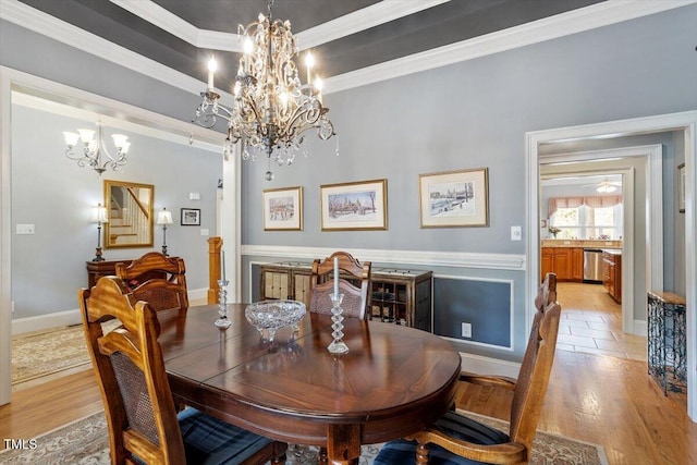 1525 Marshall Farm St, Wake Forest, NC 27587 - dining area featuring light wood finished floors, baseboards, crown molding, and an inviting chandelier
