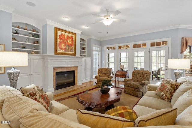 1525 Marshall Farm St, Wake Forest, NC 27587 - living area featuring built in features, a tiled fireplace, ceiling fan, and ornamental molding