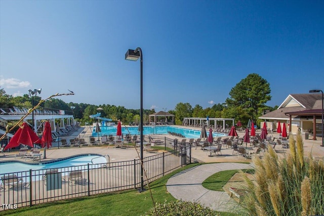 1525 Marshall Farm St, Wake Forest, NC 27587 - community pool featuring a water slide, fence, and a patio area
