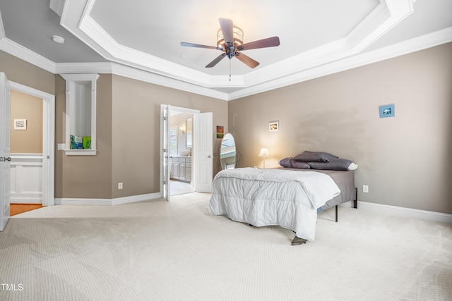 3821 Falls River Ave, Raleigh, NC 27614 - bedroom with crown molding, a tray ceiling, light colored carpet, connected bathroom, and baseboards