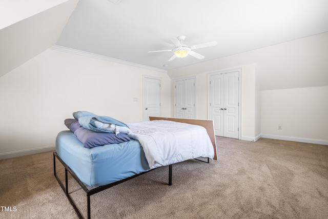 3821 Falls River Ave, Raleigh, NC 27614 - bedroom featuring carpet floors, two closets, vaulted ceiling, baseboards, and a ceiling fan