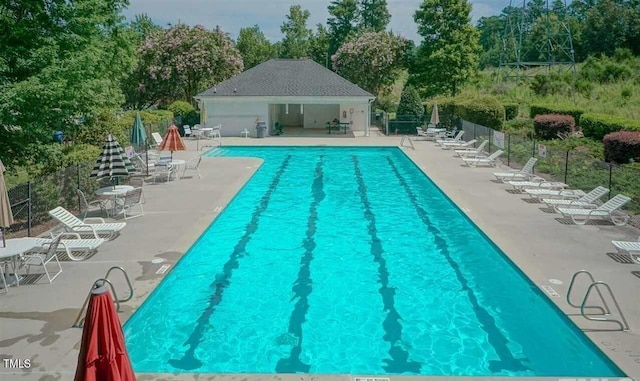 6705 Somerknoll Dr, Durham, NC 27713 - community pool with a patio and view of wooded area