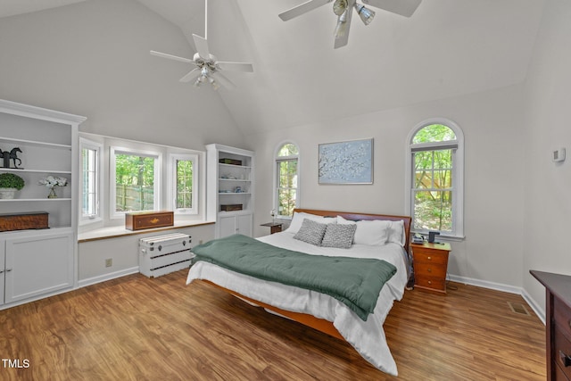 63 Tally Ho Dr, Selma, NC 27576 - bedroom featuring high vaulted ceiling, light wood-style flooring, multiple windows, ceiling fan, and baseboards