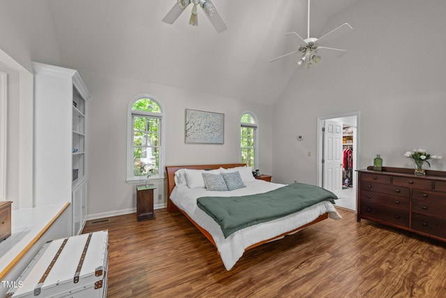 63 Tally Ho Dr, Selma, NC 27576 - bedroom featuring multiple windows, high vaulted ceiling, wood finished floors, a walk in closet, and ceiling fan