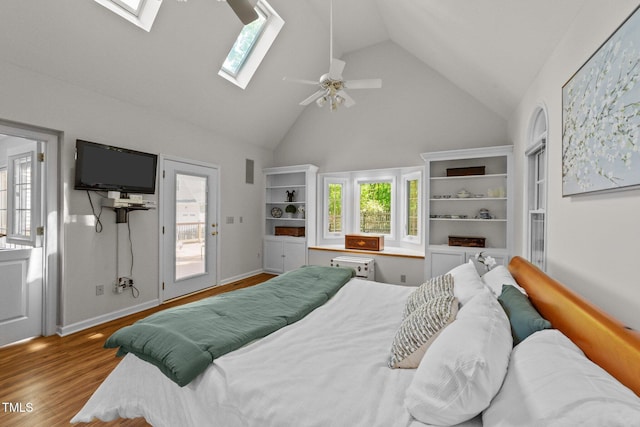 63 Tally Ho Dr, Selma, NC 27576 - bedroom with a skylight, high vaulted ceiling, wood finished floors, a ceiling fan, and baseboards
