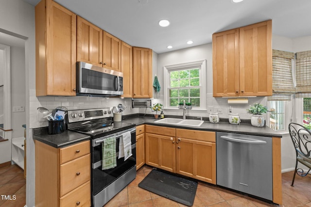 63 Tally Ho Dr, Selma, NC 27576 - kitchen featuring appliances with stainless steel finishes, a sink, dark countertops, and recessed lighting