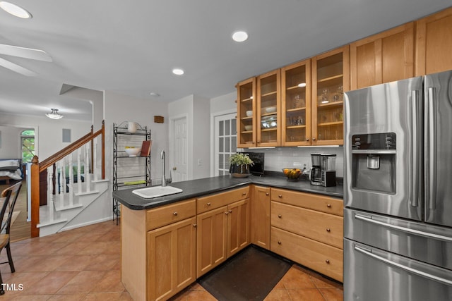 63 Tally Ho Dr, Selma, NC 27576 - kitchen featuring stainless steel refrigerator with ice dispenser, a peninsula, a ceiling fan, backsplash, and light tile patterned floors