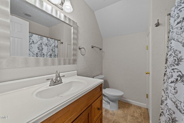 63 Tally Ho Dr, Selma, NC 27576 - bathroom featuring vaulted ceiling, vanity, a textured wall, toilet, and a shower with curtain
