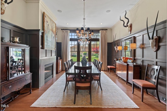 417 Westbury Dr, Chapel Hill, NC 27516 - dining space featuring a decorative wall, an inviting chandelier, crown molding, and wood finished floors