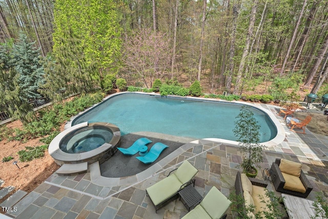 417 Westbury Dr, Chapel Hill, NC 27516 - view of swimming pool with a patio area, a pool with connected hot tub, and a view of trees