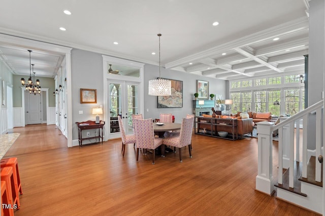 417 Westbury Dr, Chapel Hill, NC 27516 - dining area with beam ceiling, a wealth of natural light, an inviting chandelier, and light wood-style floors