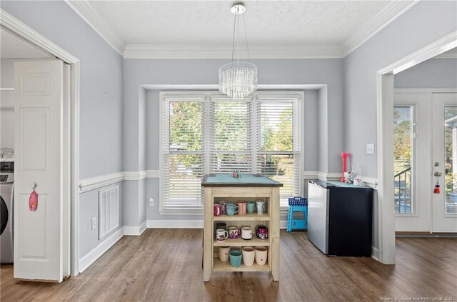 1010 Blue Wren Dr, Fayetteville, NC 28312 - dining space featuring a chandelier, wood finished floors, washer / dryer, visible vents, and ornamental molding