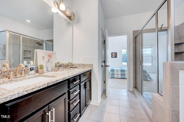 bathroom featuring a shower stall, tile patterned floors, and a sink