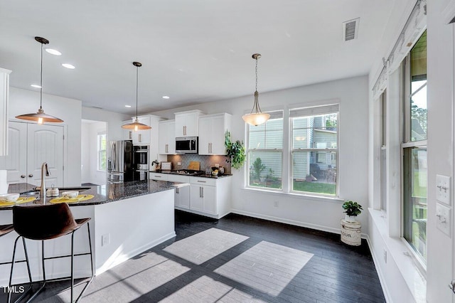 kitchen featuring recessed lighting, white cabinetry, visible vents, appliances with stainless steel finishes, and a sink