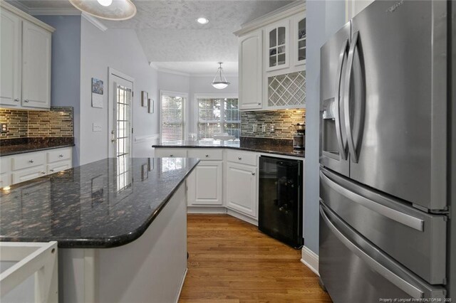6826 Surrey Rd, Fayetteville, NC 28306 - kitchen with white cabinets, light wood-style flooring, a peninsula, wine cooler, and stainless steel refrigerator with ice dispenser